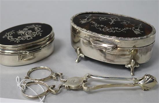 Two early 20th century silver and tortoiseshell piqué oval boxes and a pair of Georgian silver sugar nips.